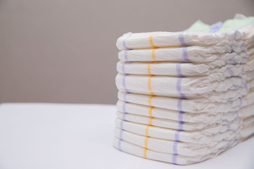 stack of baby diapers on the counter