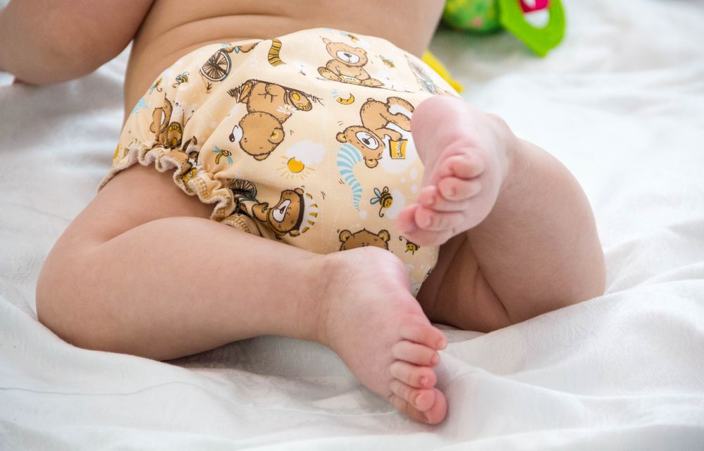 baby butt and legs in cloth diaper with teddy bears