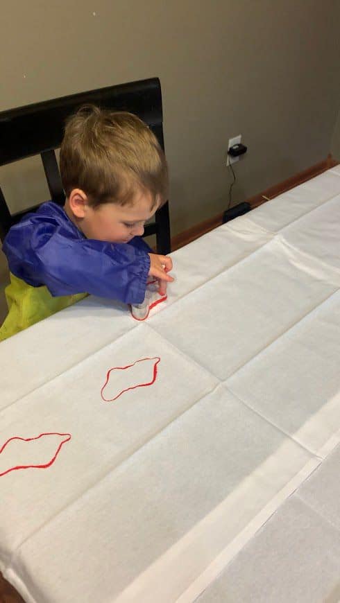 Toddler making DIY Christmas Tea Towels